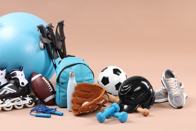 Photo of Many different sports equipment on beige background