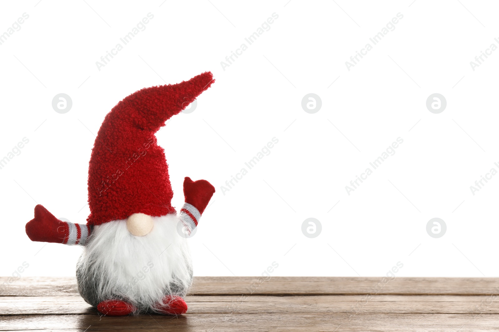 Photo of Funny Christmas gnome on wooden table against white background. Space for text