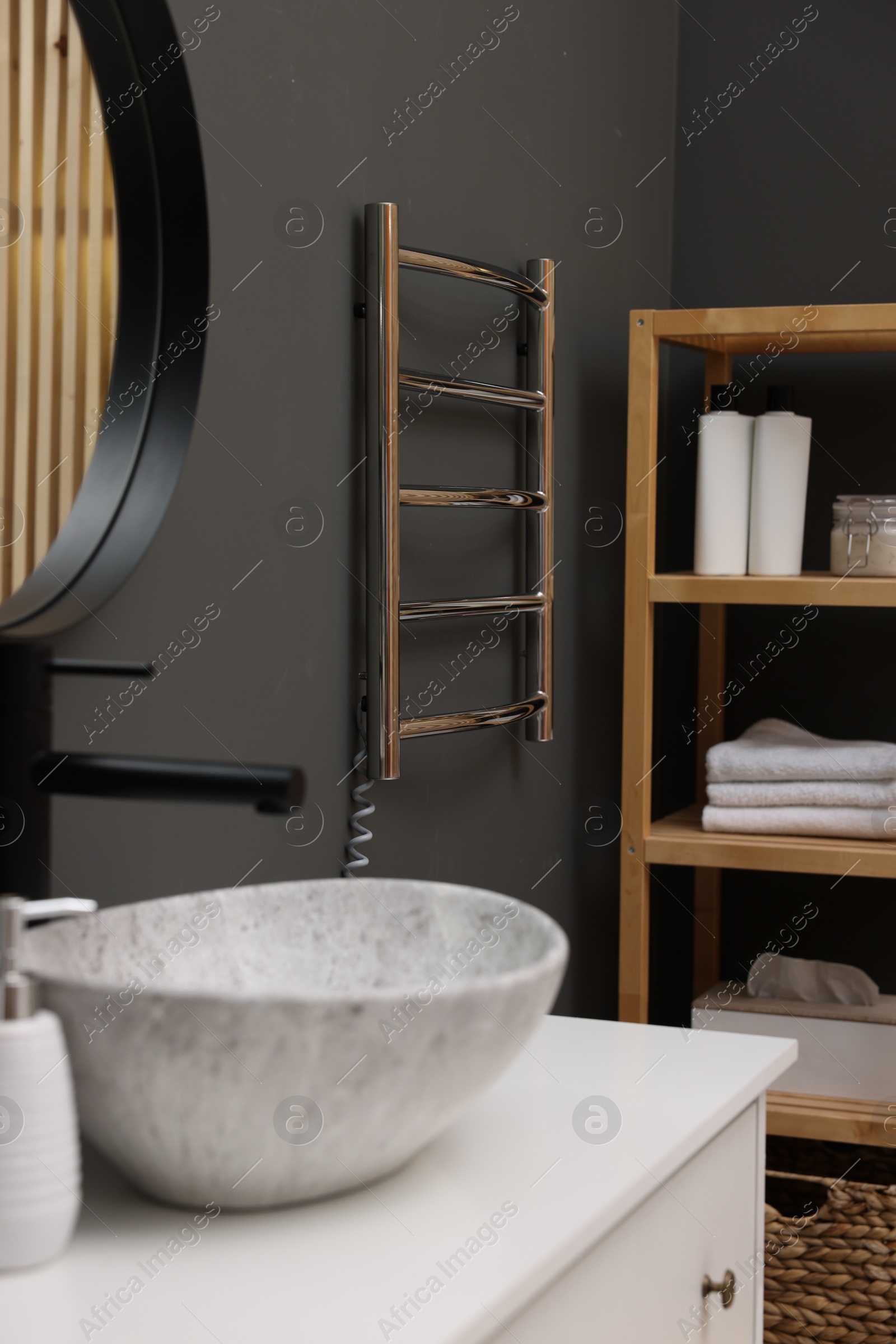 Photo of Stylish bathroom interior with heated towel rail and modern furniture