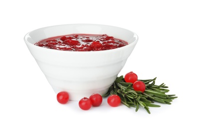 Bowl of cranberry sauce with rosemary on white background