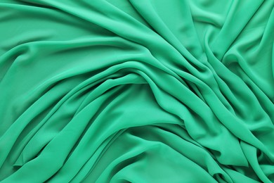 Beautiful green tulle fabric as background, top view