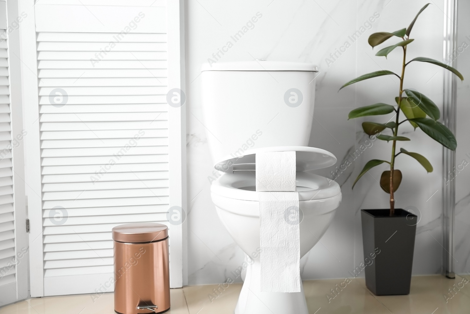 Photo of New paper roll on toilet seat in bathroom