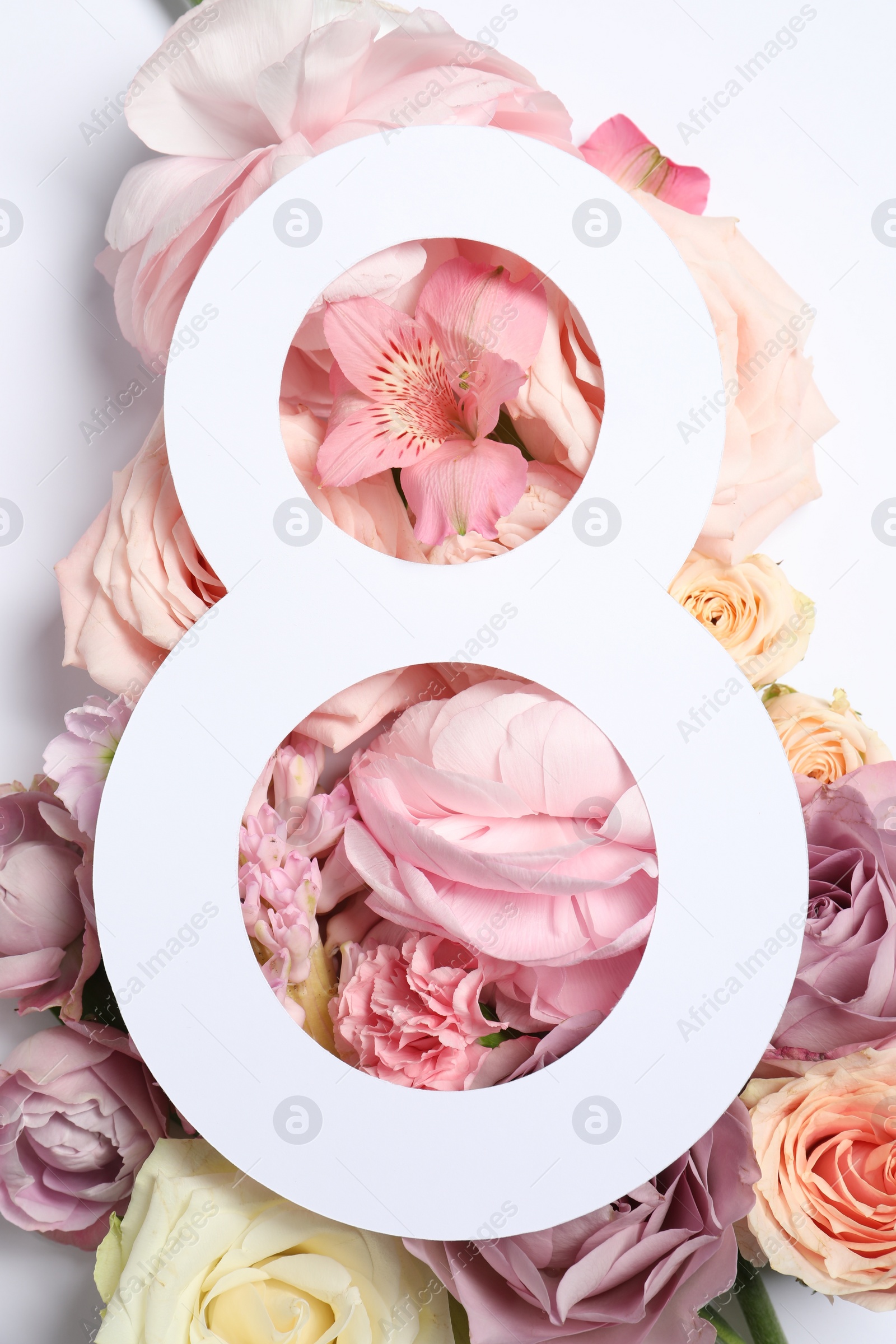 Photo of 8 March greeting card design with flowers on white background, top view. Happy International Women's Day