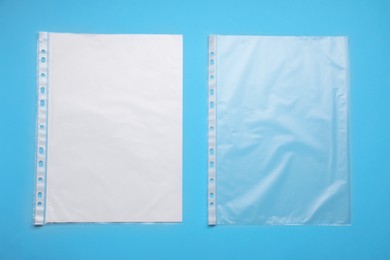 Photo of Punched pockets on light blue background, flat lay. Space for text