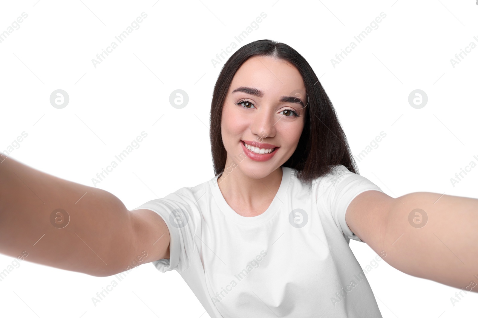 Photo of Smiling young woman taking selfie on white background