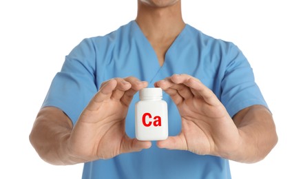 Calcium supplement. Doctor holding bottle with pills on white background, closeup