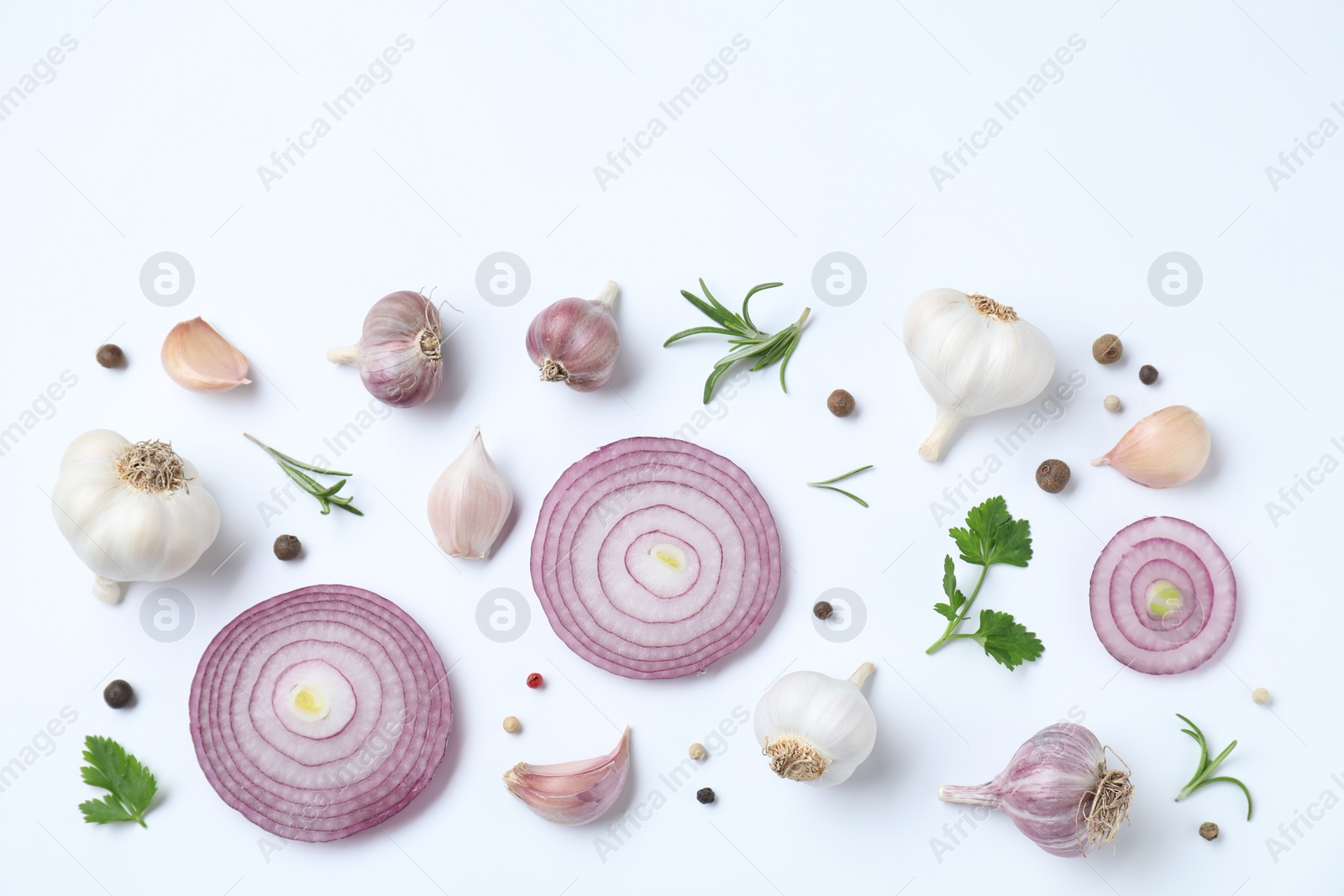 Photo of Fresh garlic, onion rings and spices on white table, flat lay