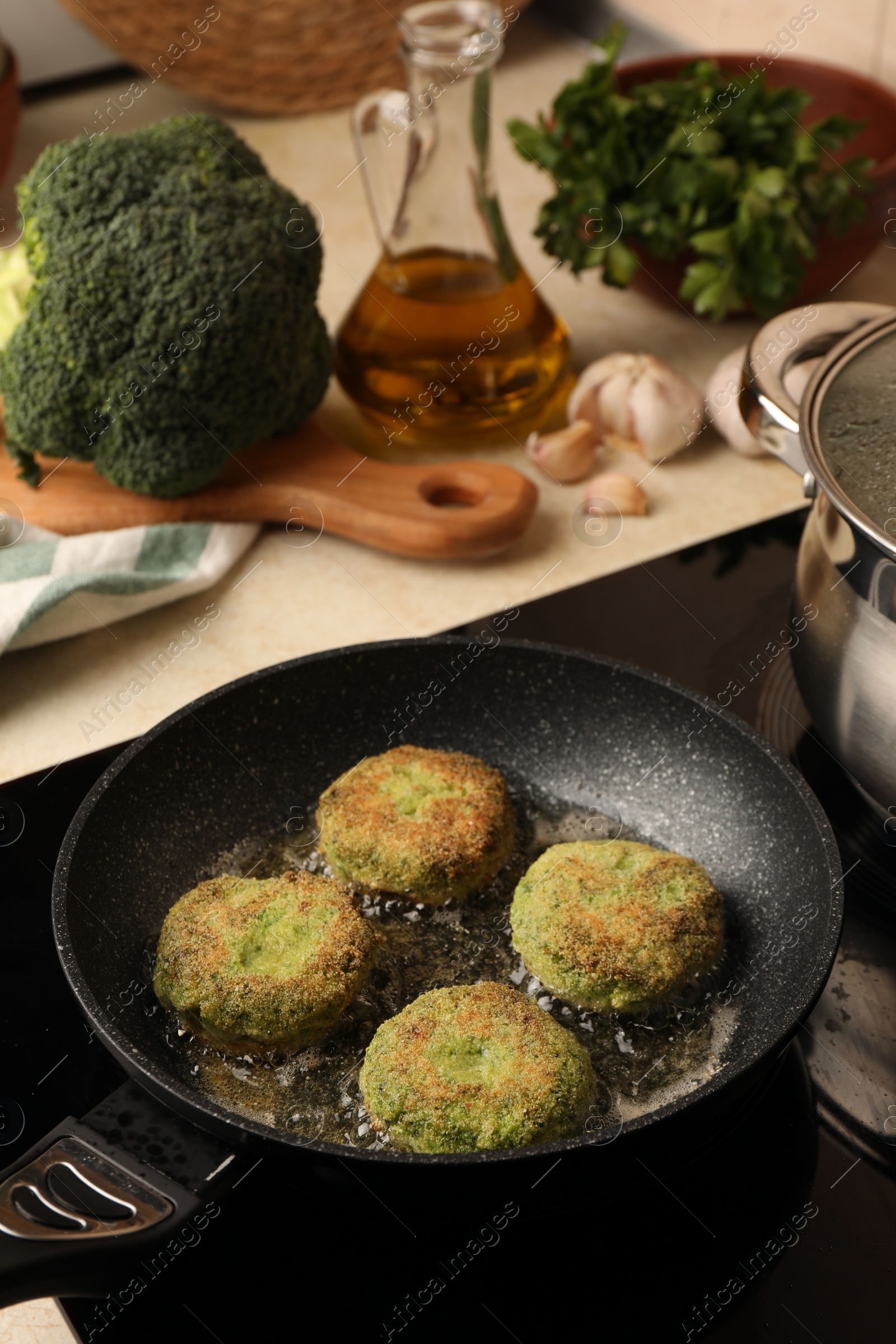 Photo of Cooking vegan cutlets in frying pan on stove