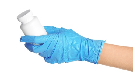 Doctor in medical glove holding bottle with pills on white background