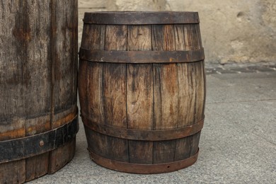 Photo of Traditional wooden barrels on street outdoors. Wine making