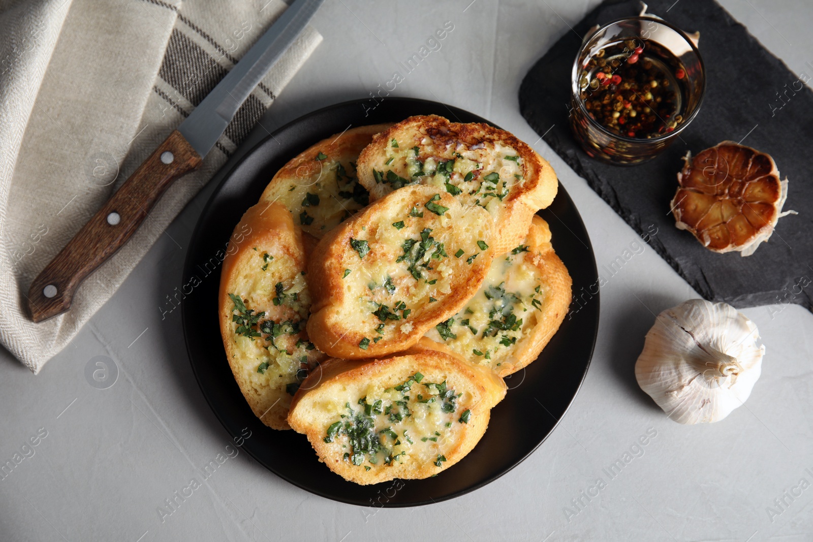 Photo of Flat lay composition with tasty garlic bread on table