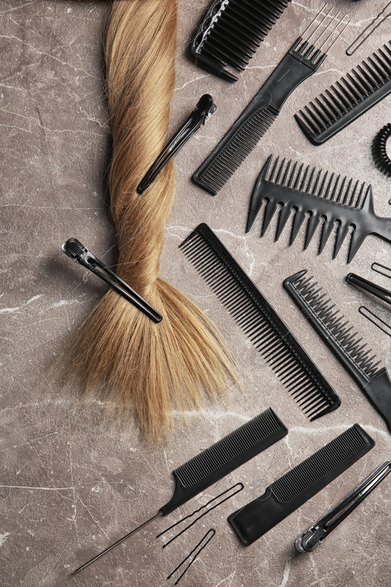 Photo of Flat lay composition with hair salon tools on grey background