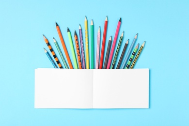 Photo of Different stationery and notebook on light blue background, flat lay with space for text. Back to school
