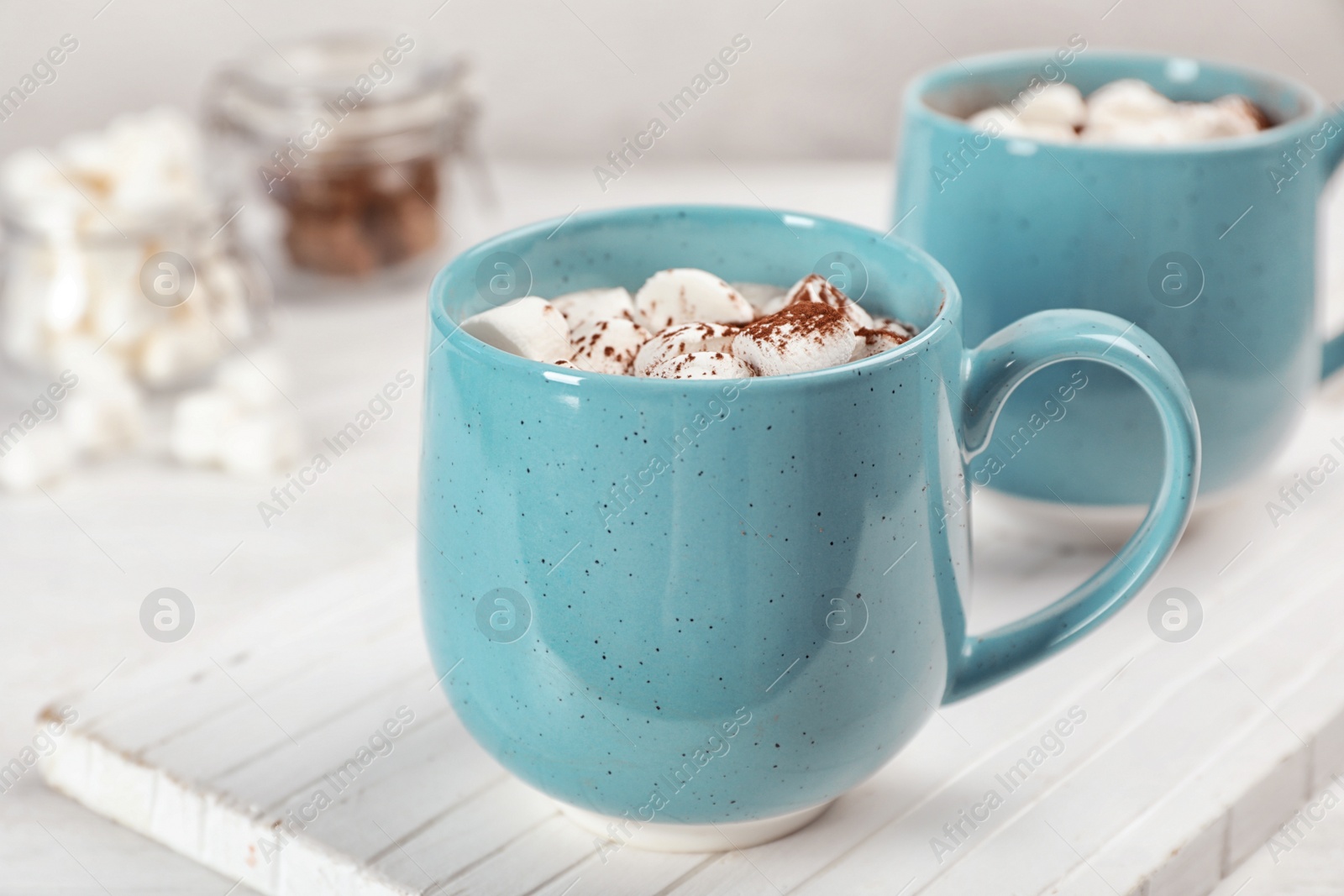 Photo of Cup of chocolate milk on light wooden background