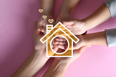 Image of Illustration of house and happy family holding hands on pink background, top view