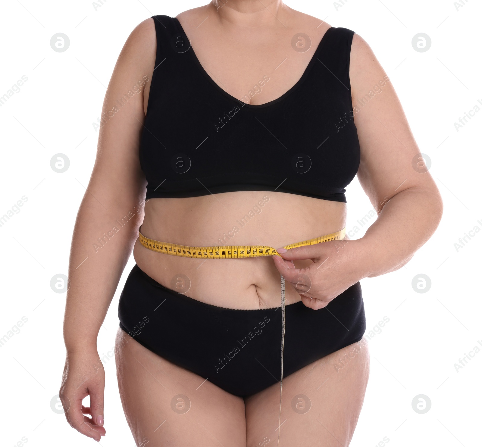 Photo of Overweight woman in underwear measuring waist with tape on white background, closeup