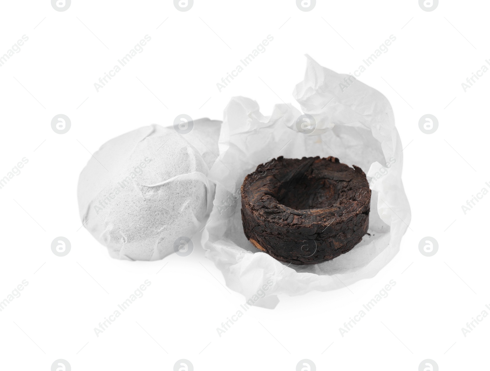 Photo of Cake shaped traditional Chinese pu-erh tea with paper wrap isolated on white