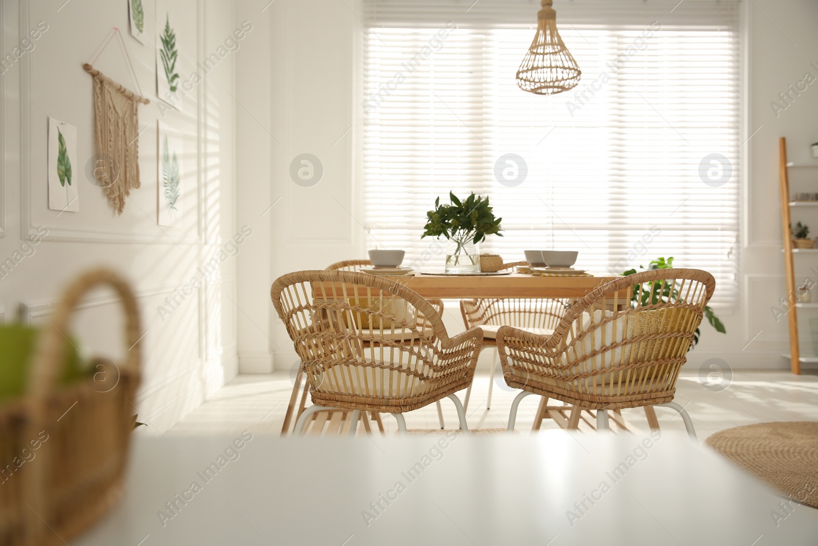 Photo of Stylish wooden dining table and chairs in room. Interior design