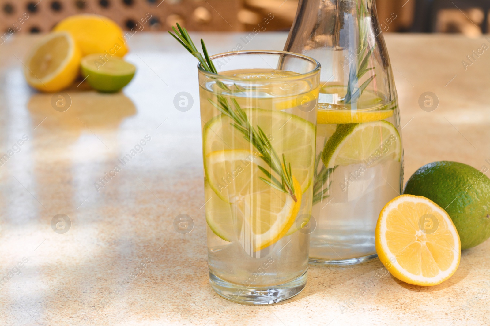 Photo of Summer refreshing lemonade on light table in cafe, space for text