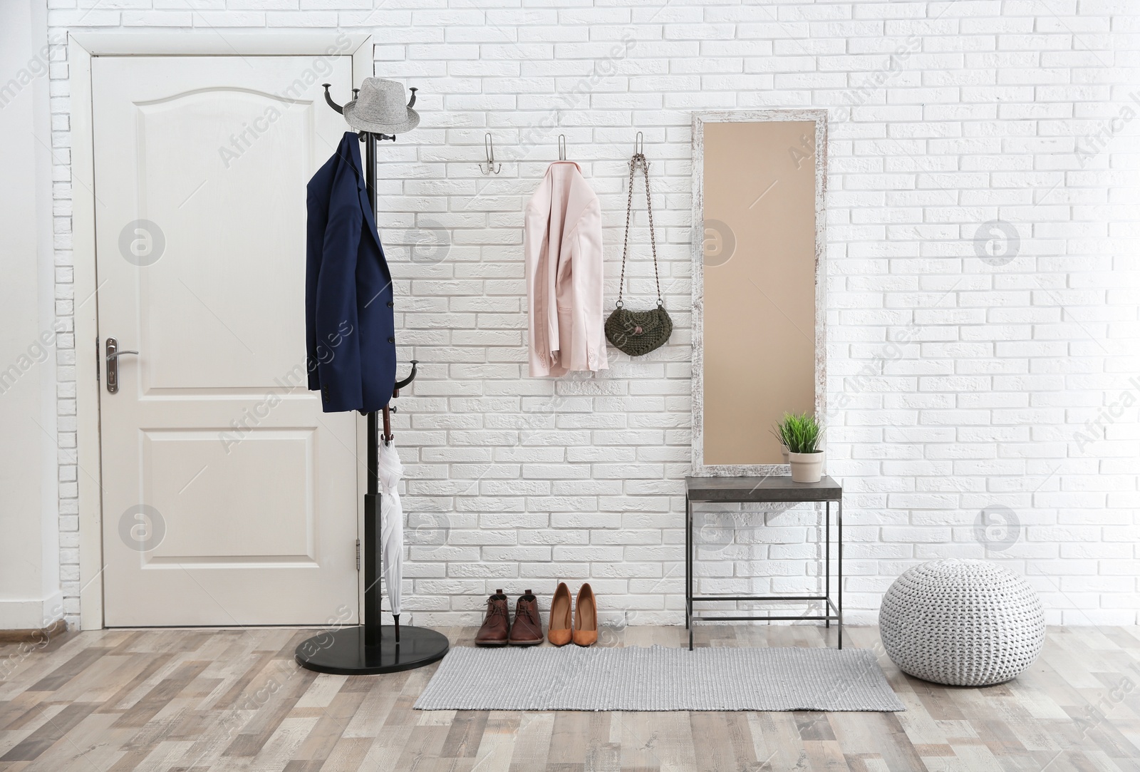 Photo of Stylish hallway interior with door and comfortable furniture