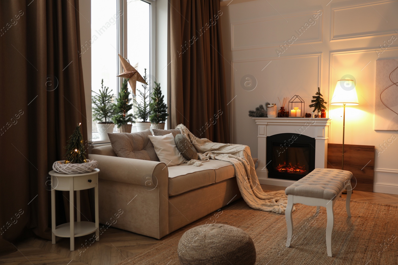 Photo of Fireplace in room with Christmas decorations. Interior design