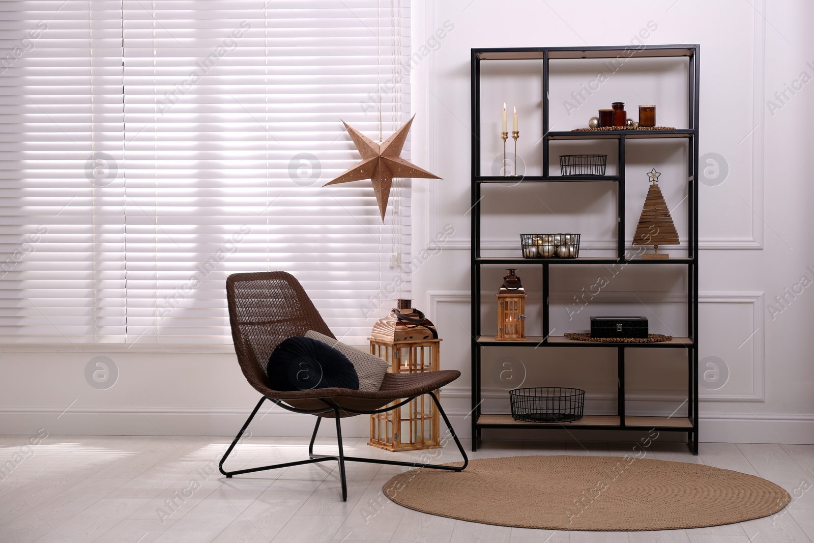 Photo of Stylish room interior with shelving unit and Christmas decor. Modern design