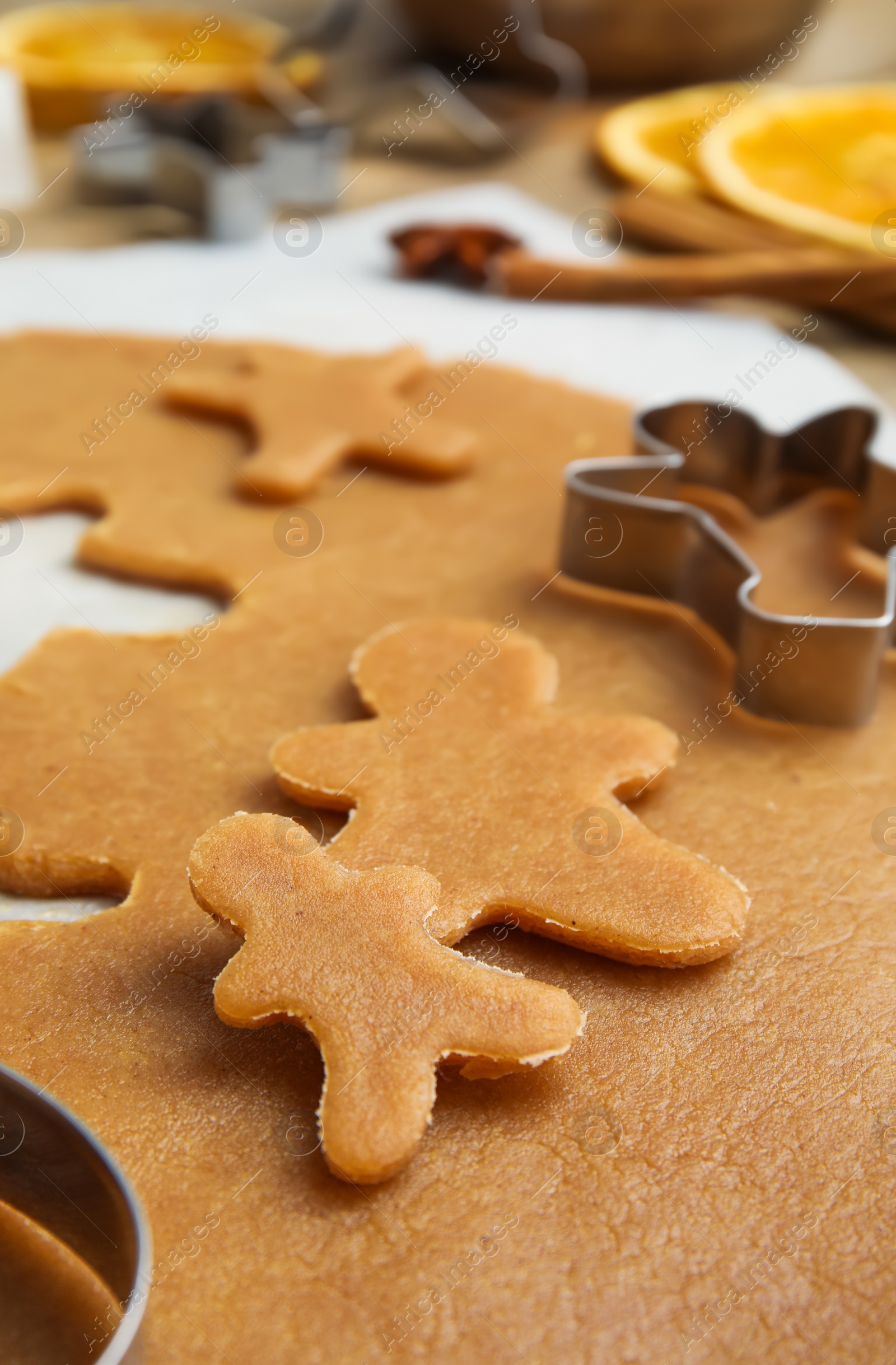 Photo of Dough and cookie cutter on table, closeup