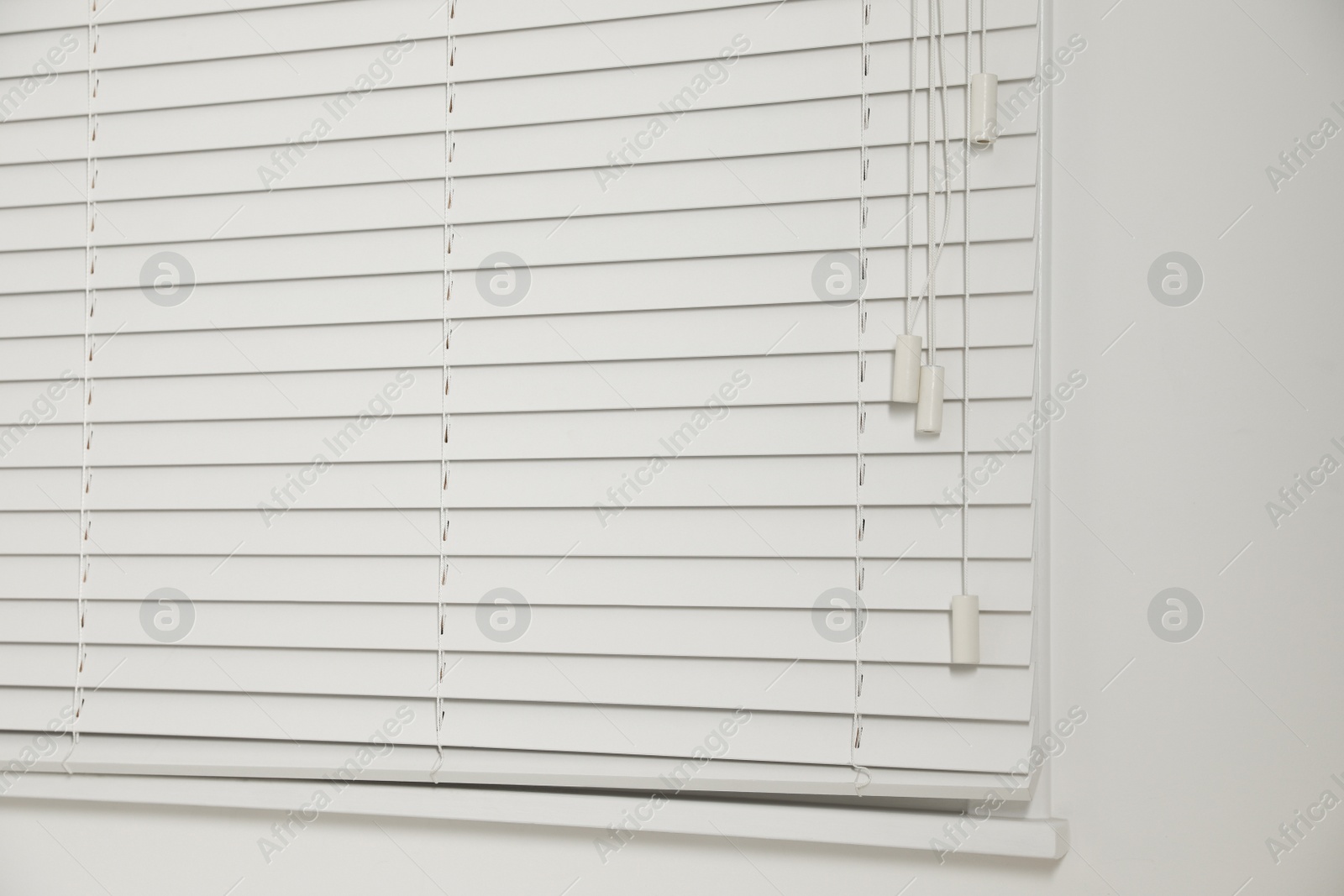 Photo of Window with closed blinds in room, closeup