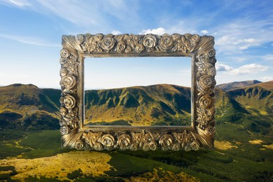 Image of Vintage frame and beautiful mountains under blue sky with clouds