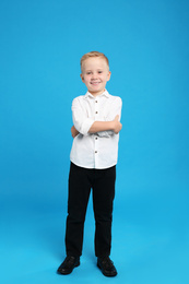 Photo of Full length portrait of cute little boy on light blue background