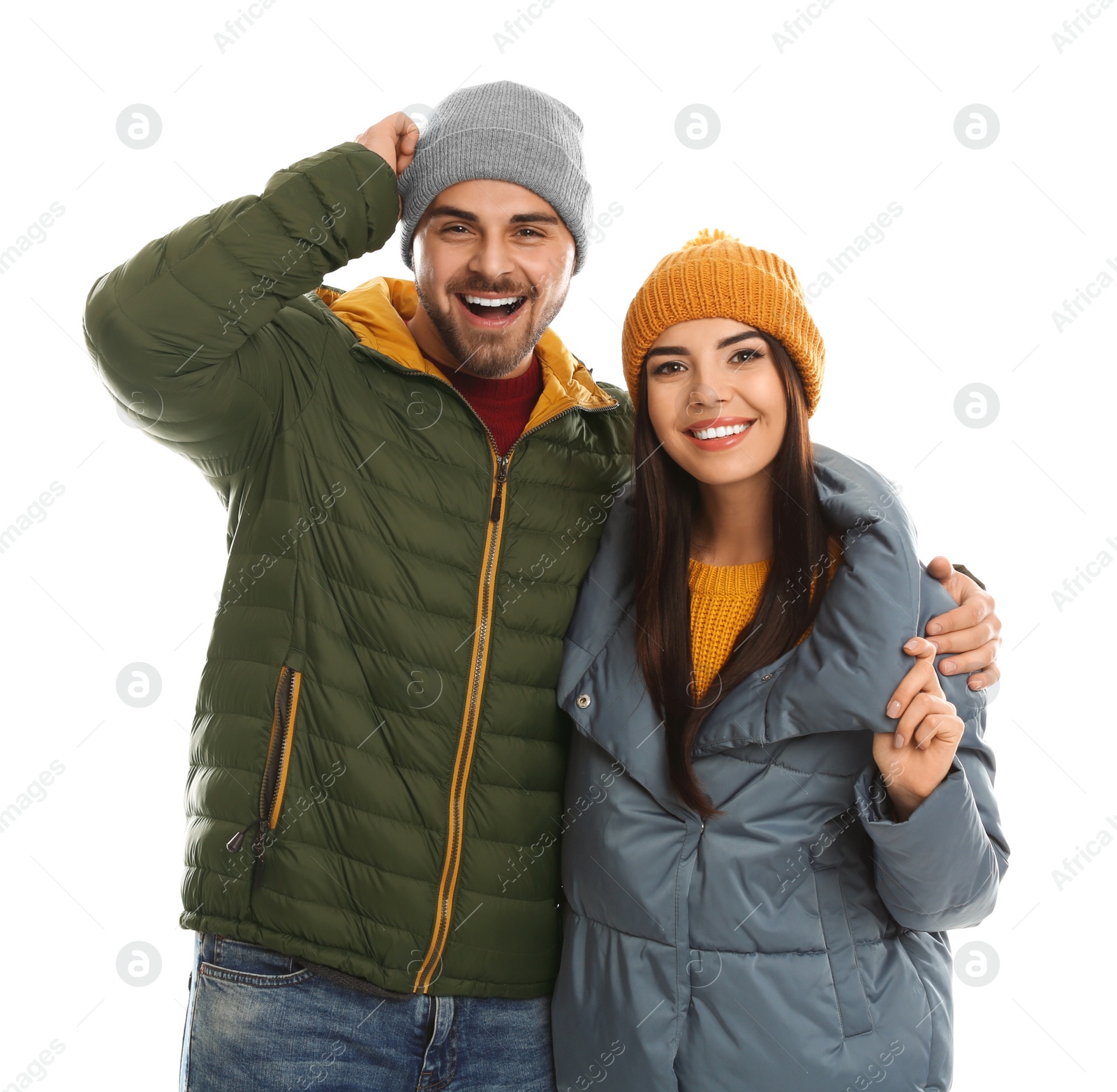 Photo of Happy young couple in warm clothes on white background. Winter vacation