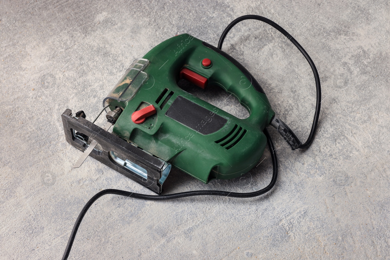 Photo of Green jigsaw on floor in room prepared for renovation