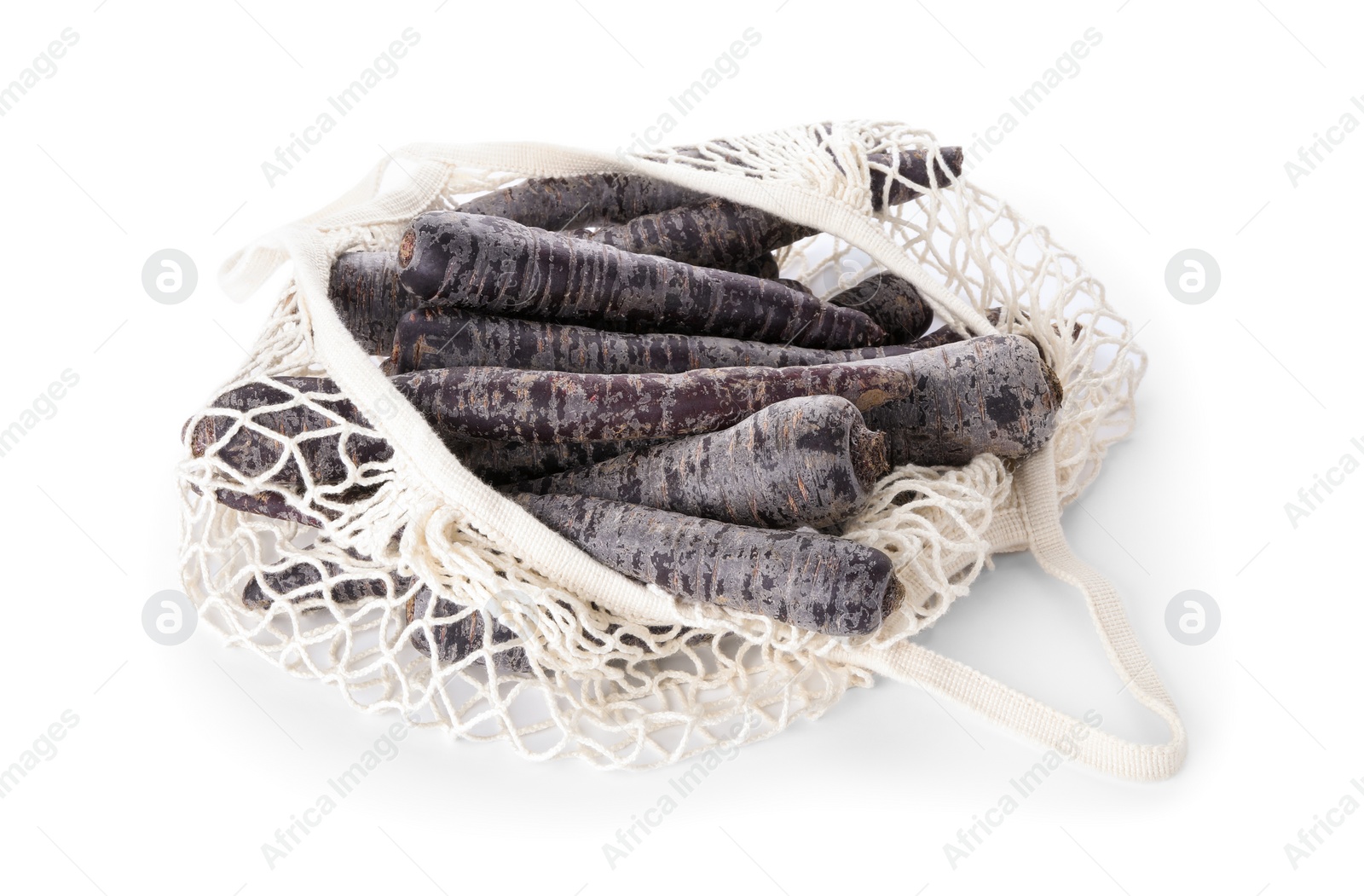 Photo of Raw black carrots in mesh bag isolated on white