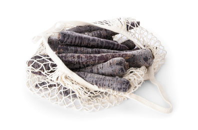 Photo of Raw black carrots in mesh bag isolated on white