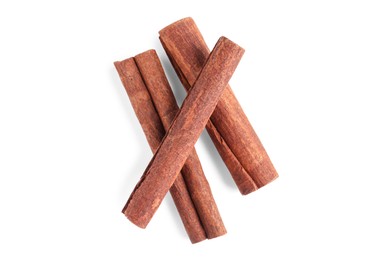 Photo of Cinnamon sticks isolated on white, top view