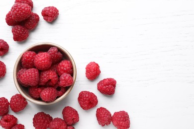 Tasty ripe raspberries on white wooden table, flat lay. Space for text