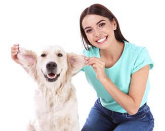 Young woman and her Golden Retriever dog on white background