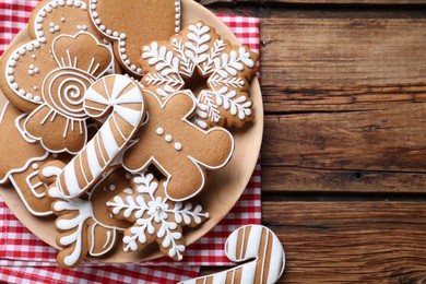 Delicious gingerbread Christmas cookies on wooden table, flat lay