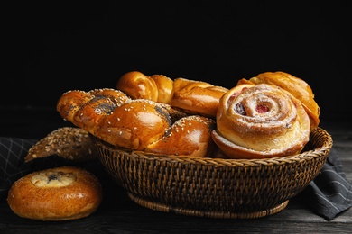 Different delicious fresh pastries on dark wooden table