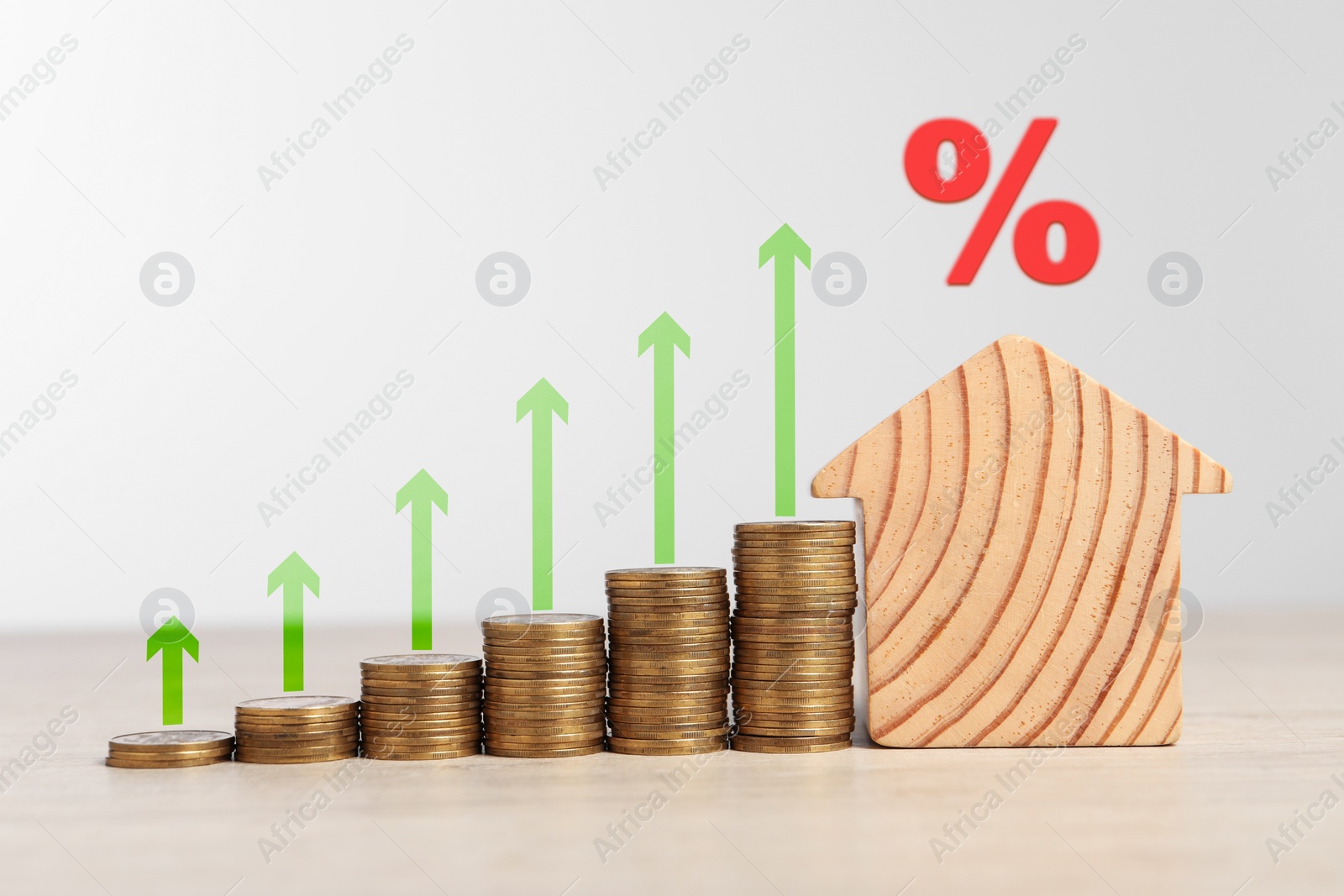 Image of Mortgage rate. Wooden model of house, stacked coins, arrows and percent sign