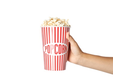 Woman holding cup with delicious popcorn on white background, closeup