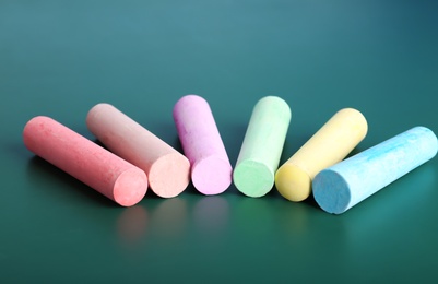 Photo of Color pieces of chalk on table, closeup