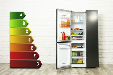 Energy efficiency rating label and open refrigerator indoors