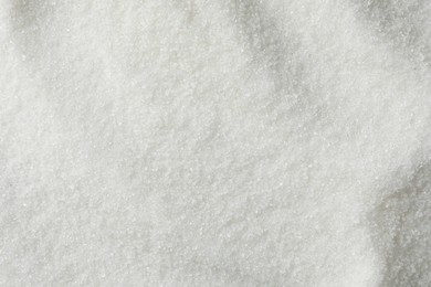 Photo of White granulated sugar as background, top view