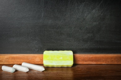 Photo of Chalk and duster on table in classroom