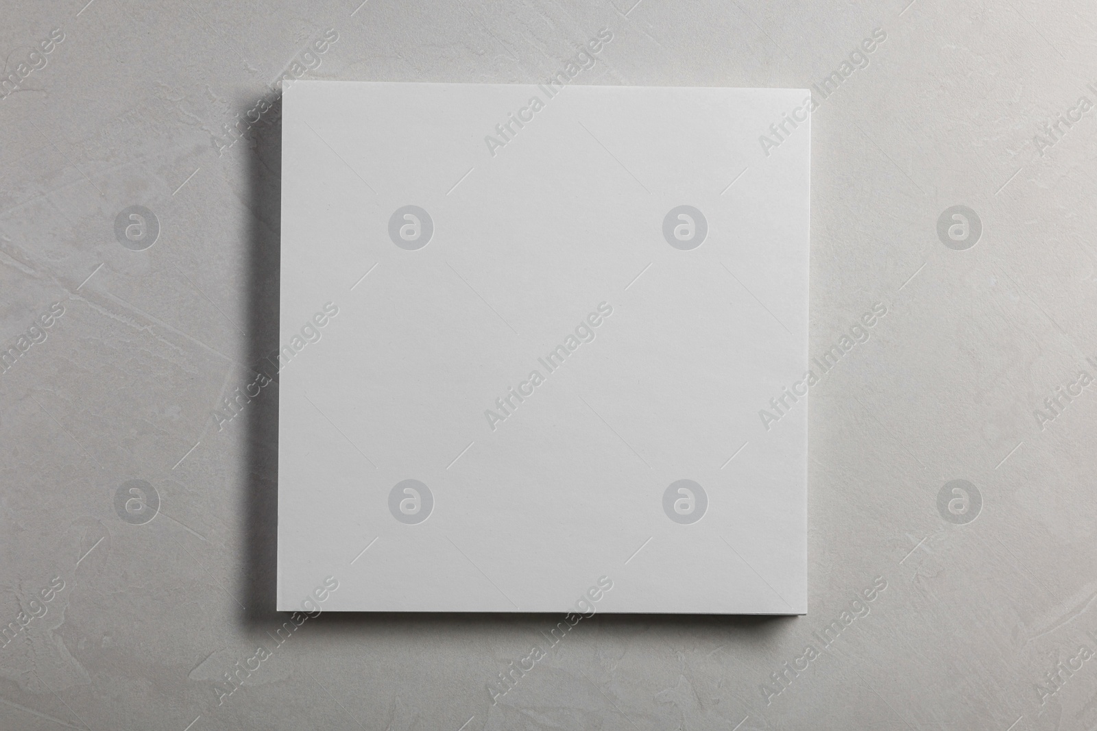 Photo of Blank paper sheets on grey textured background, top view. Mockup for design