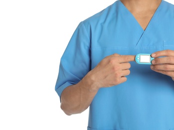 Male doctor using heart rate monitor on white background, closeup. Medical object
