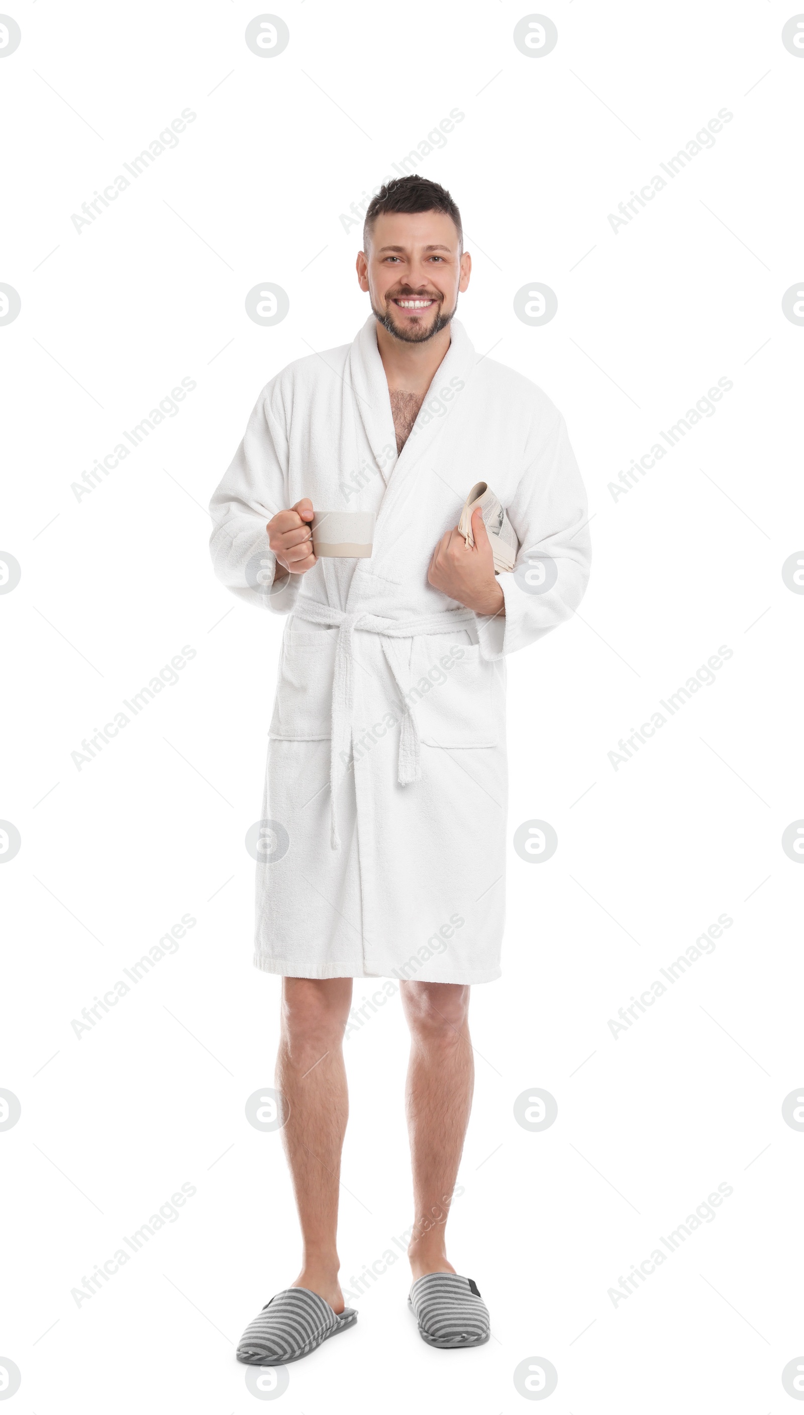 Photo of Handsome man in bathrobe with cup of coffee and newspaper on white background