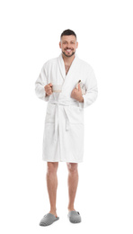 Photo of Handsome man in bathrobe with cup of coffee and newspaper on white background