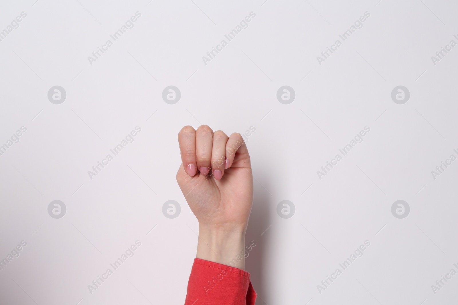 Photo of SOS gesture. Woman showing signal for help on white background, closeup